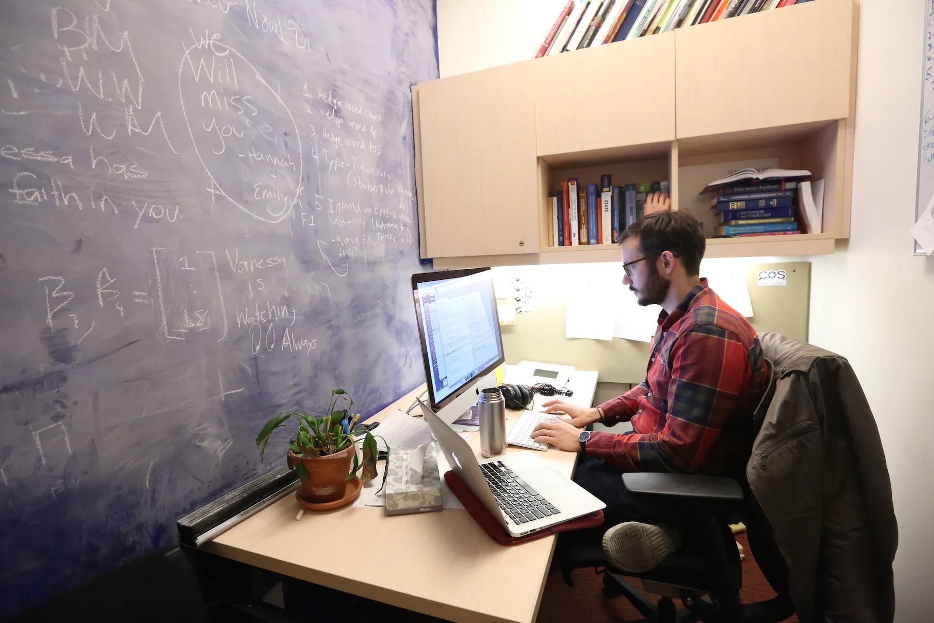 Travis sitting at his workstation